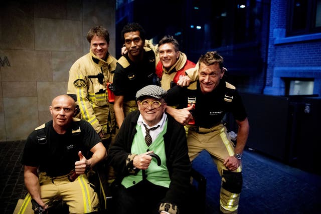 Hockney poses with his rescuers in the Netherlands after being stuck in a lift for almost half an hour