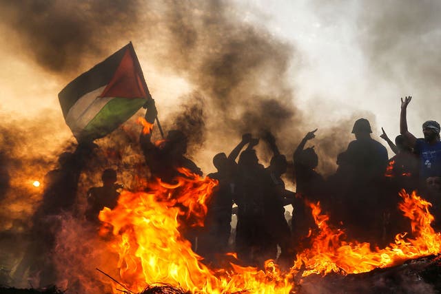 Palestinian protesters demonstrate near the border with Israel in the northern Gaza Strip last October