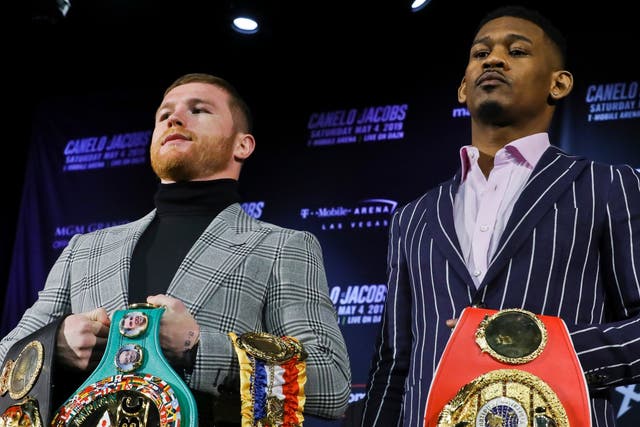 Canelo Alvarez and Danny Jacobs pose with their belts