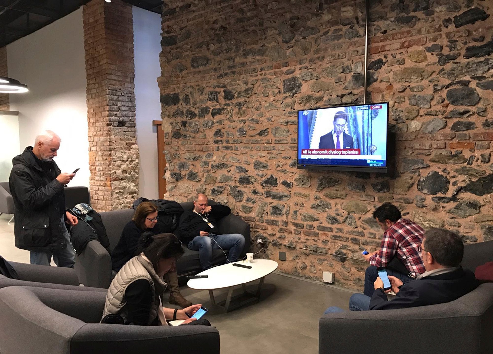 Foreign journalists who were not allowed to enter the joint news conference between Jyrki Katainen, EU Commission Vice President and Berat Albayrak, Turkey's Minister of Treasury and Finance watch conference on TV