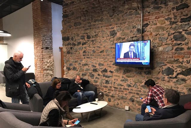 Foreign journalists who were not allowed to enter the joint news conference between Jyrki Katainen, EU Commission Vice President and Berat Albayrak, Turkey's Minister of Treasury and Finance watch conference on TV