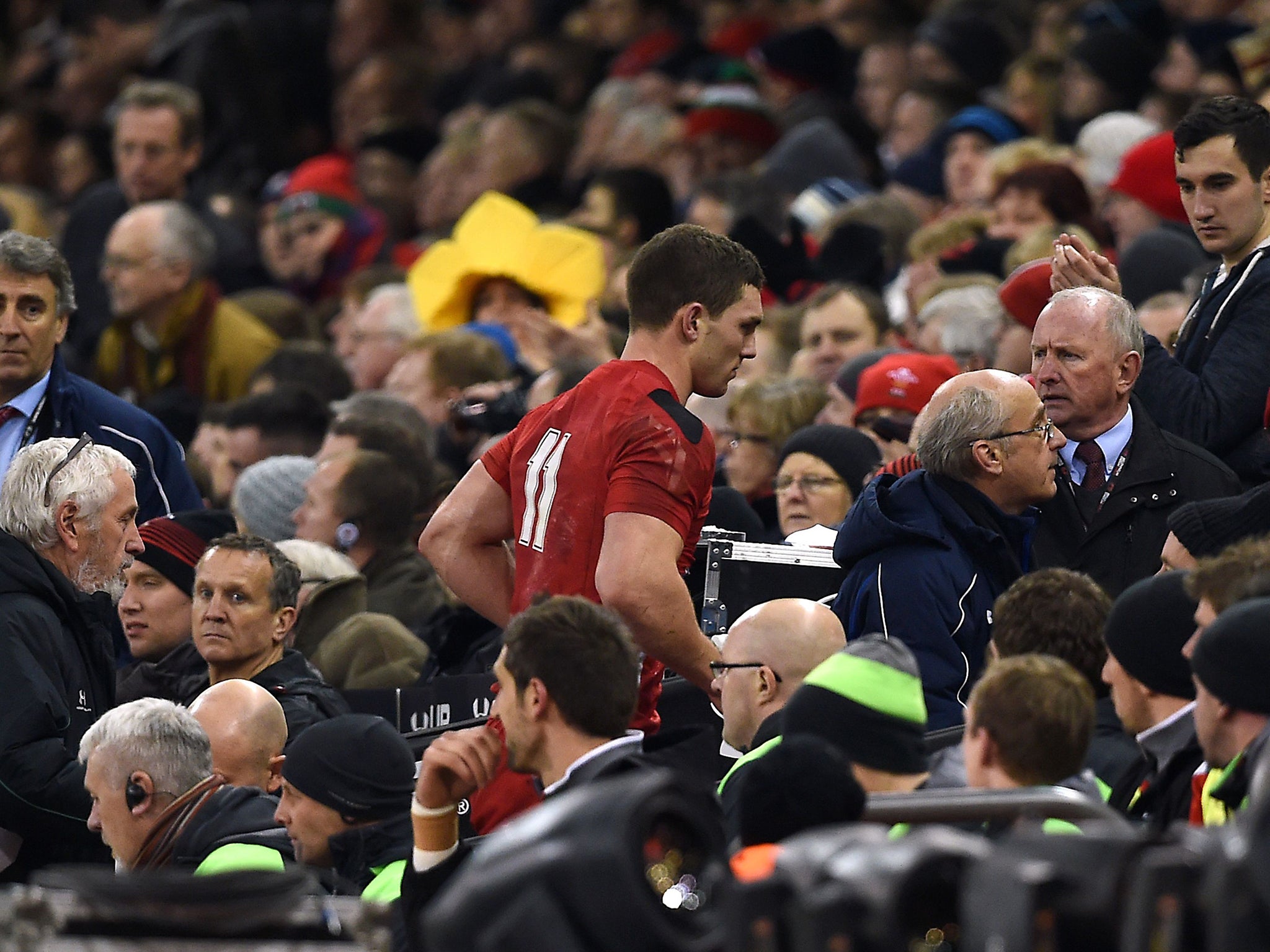 Wales wing George North leaves the field to be assessed after a head injury during a 2015 Six Nations match against England in Cardiff