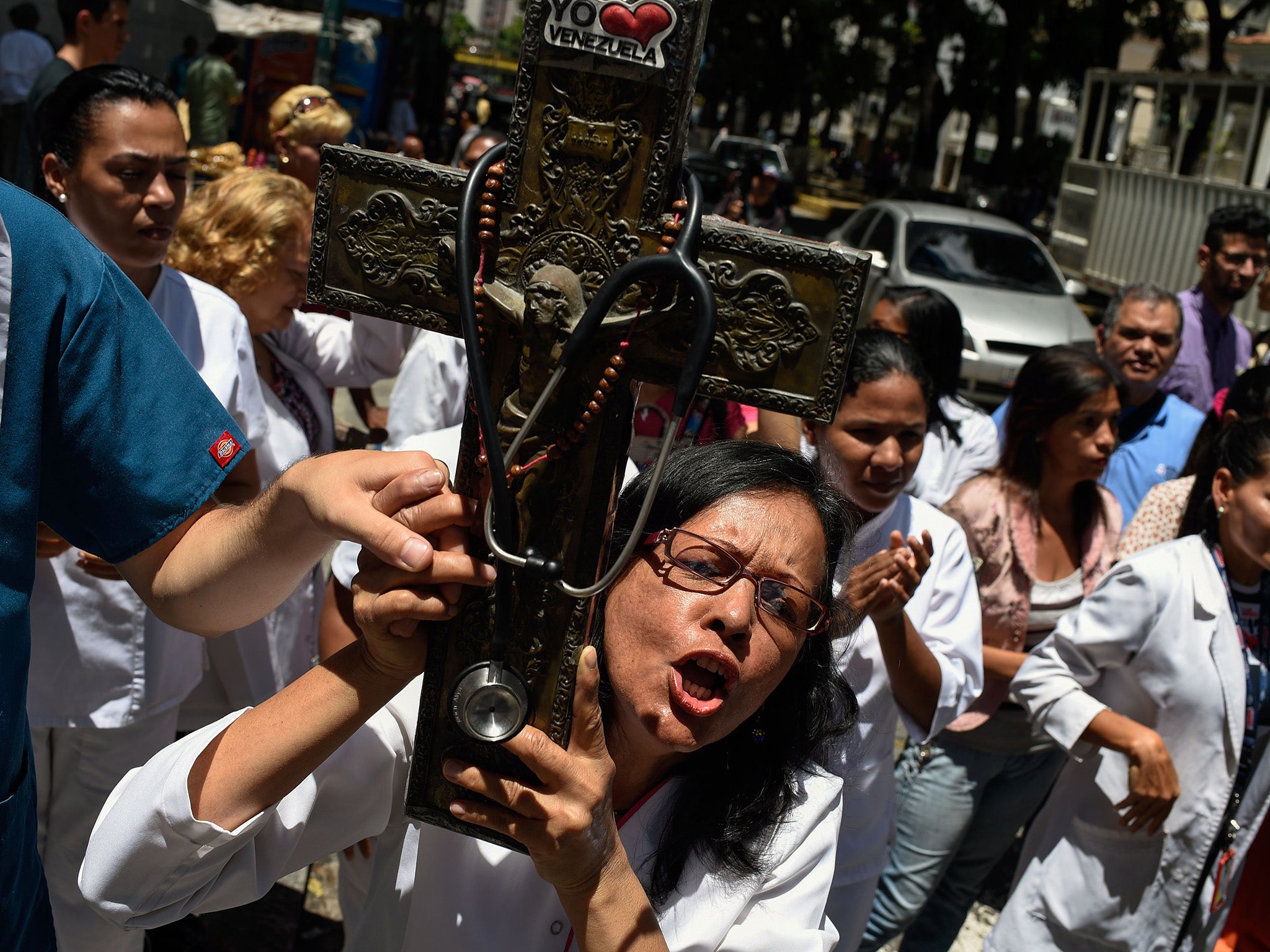 A health worker protests against low wages and poor conditions in Caracas: economic collapse has triggered an exodus of medical professionals