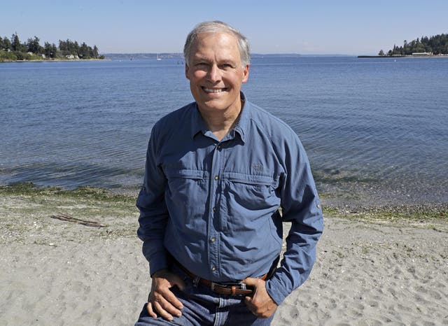 Jay Inslee poses for a photo on the beach near his home on Bainbridge Island, Washington.