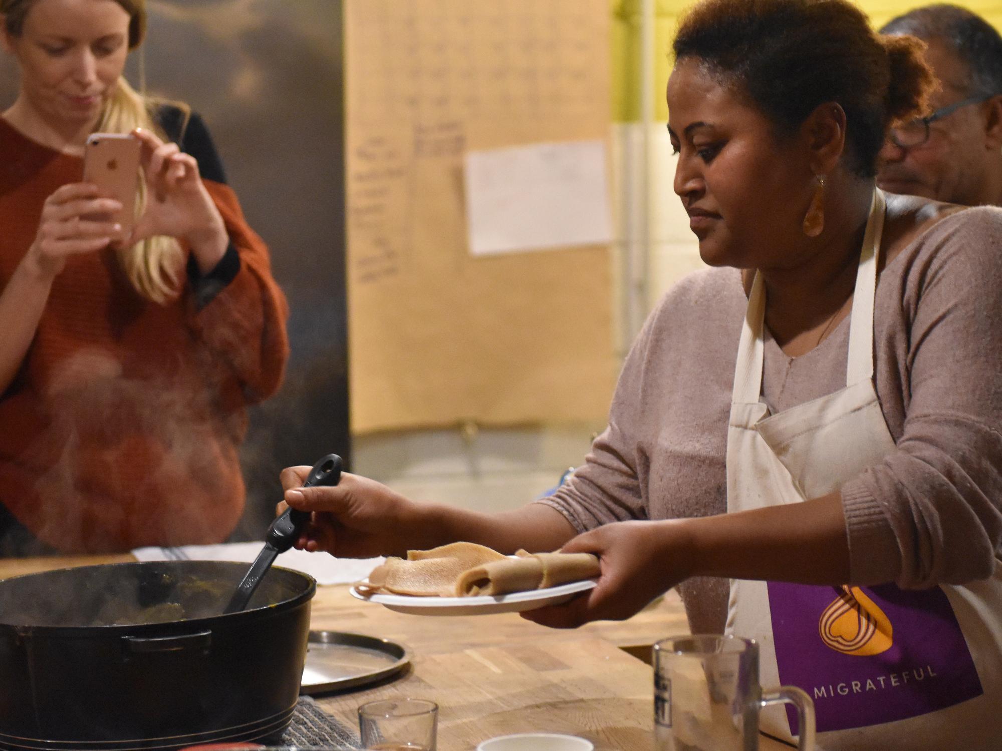 Rawa teaching students how to make her Eritrean vegetable stews and flatbread