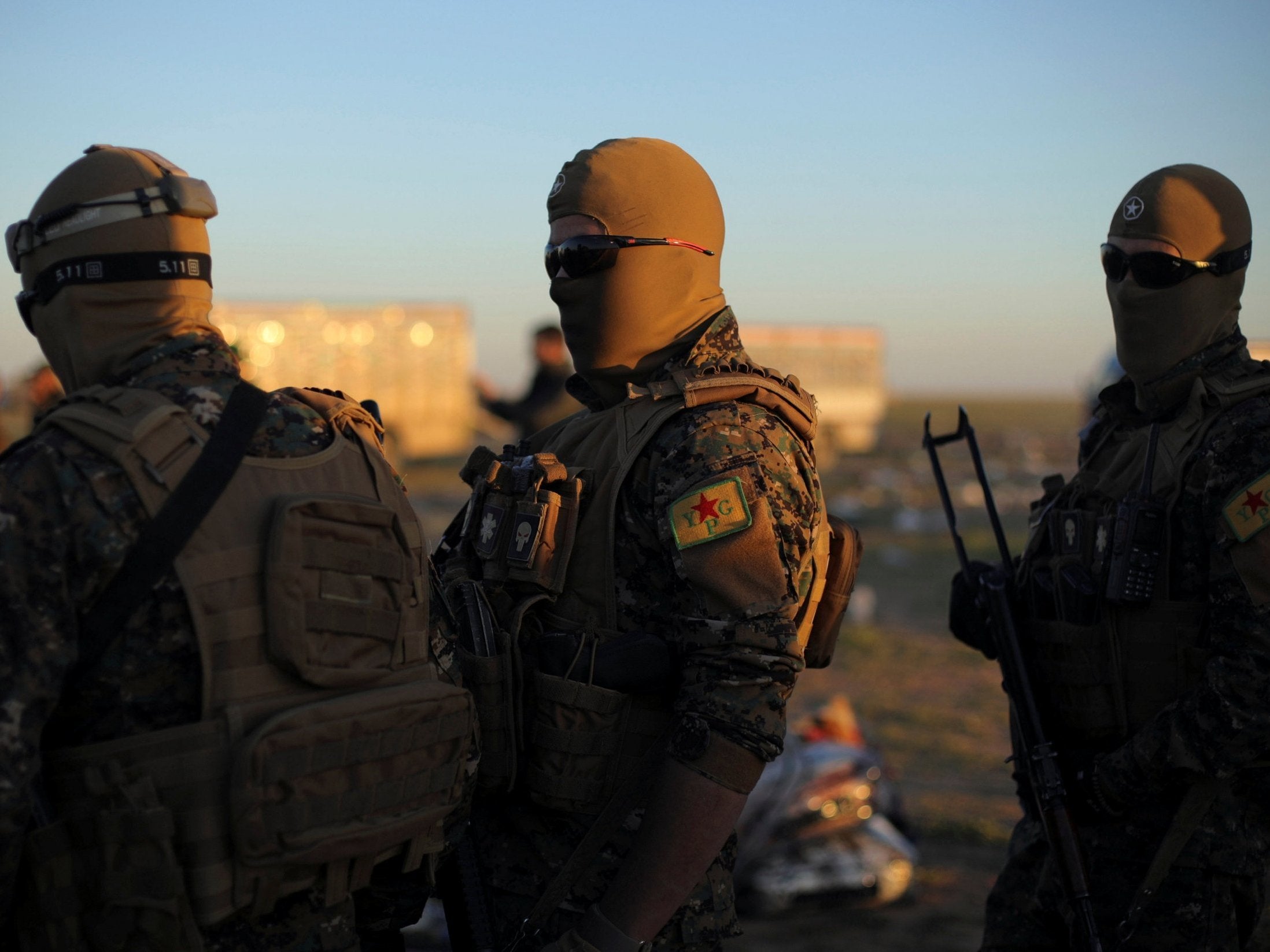 Members of the Syrian Democratic Forces stand near the village of Baghouz