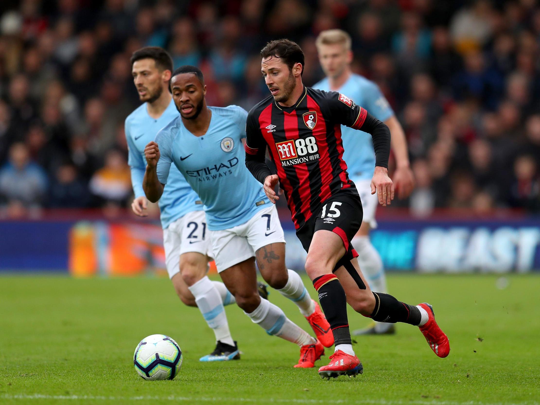 Adam Smith attempts to get away from Raheem Sterling