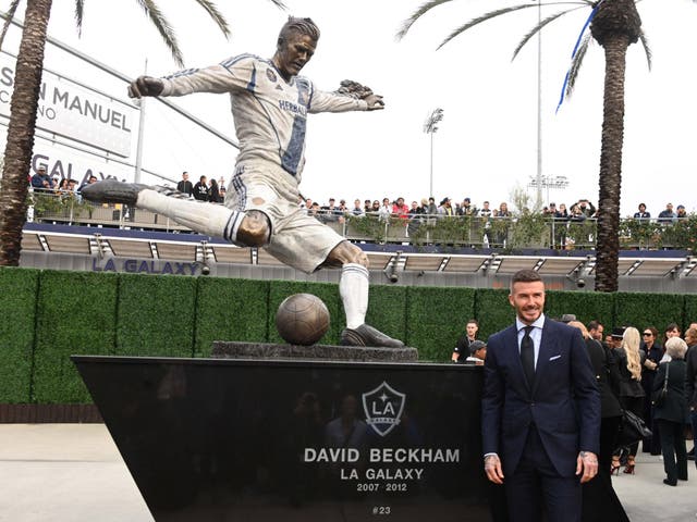 David Beckham poses during unveiling of statue