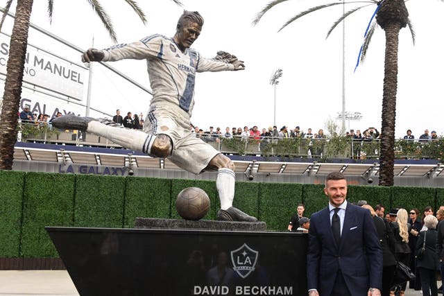 David Beckham poses during unveiling of statue