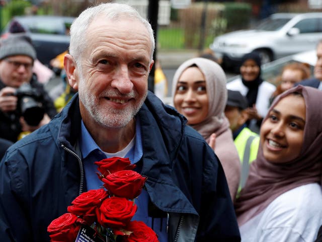 Jeremy Corbyn is greeted with red roses during a visit to Finsbury Park Mosque