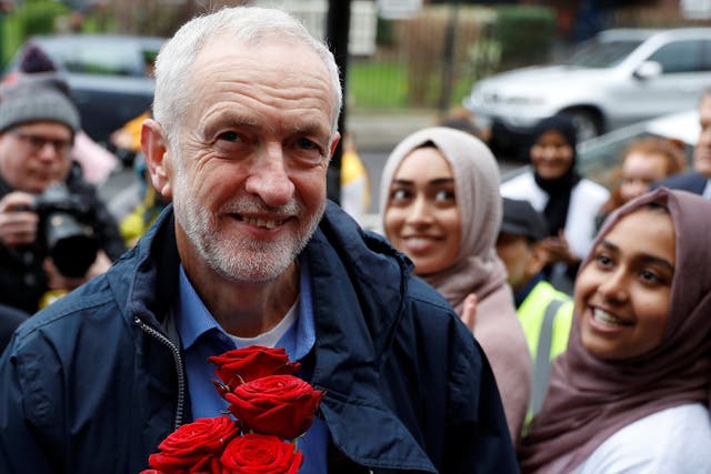 Jeremy Corbyn is greeted with red roses during a visit to Finsbury Park Mosque