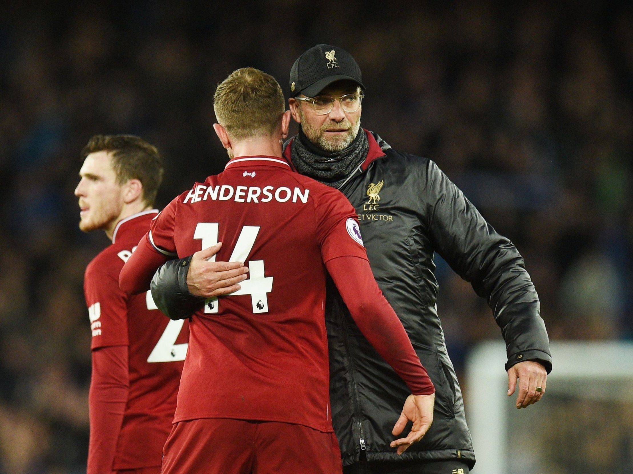 Liverpool's Jordan Henderson is embraced by manager Jurgen Klopp