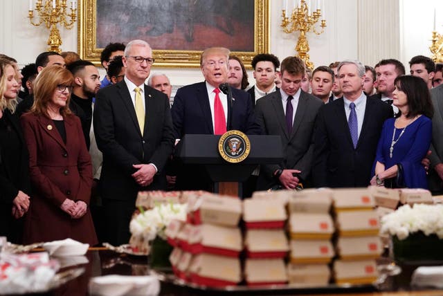 Trump speaks behind a table of fast-food during an event in honor of North Dakota State Bison team