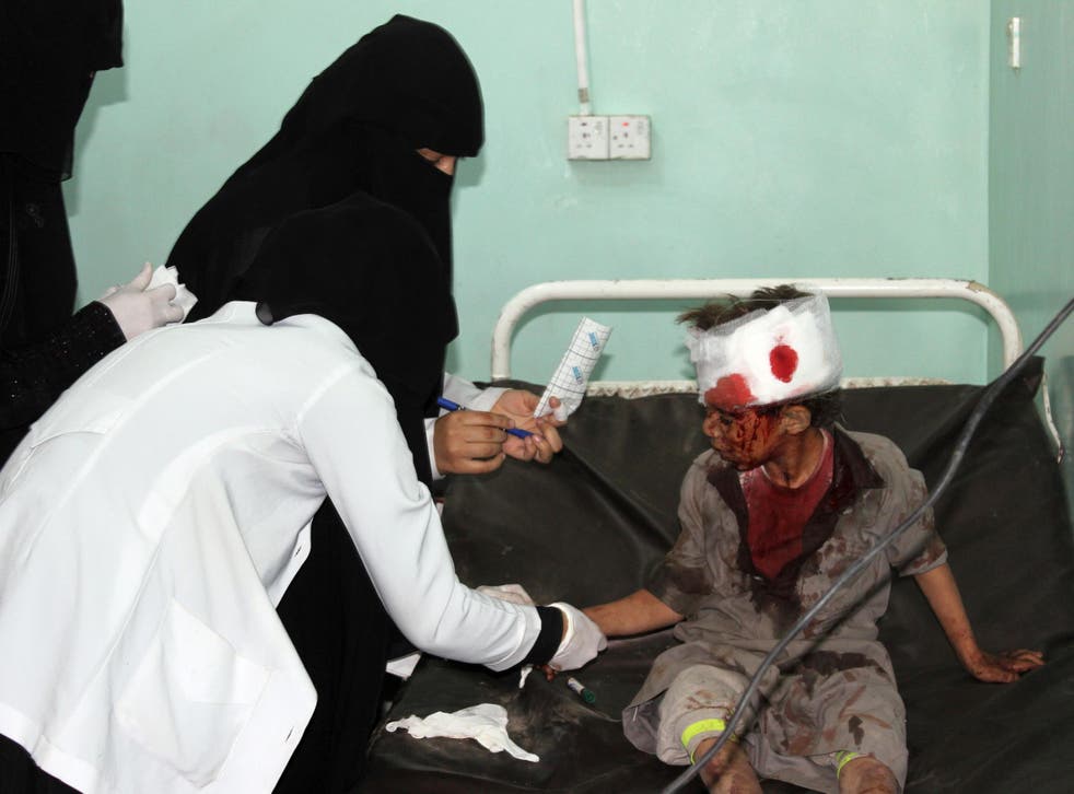 A Yemeni child receives treatment at a hospital after being wounded in a reported Saudi-led coalition air strike on a bus carrying children, leaving dozens of people dead or wounded