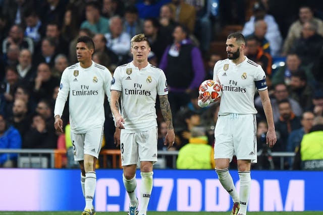 Karim Benzema, Toni Kroos and Raphael Verane of Real Madrid look dejected