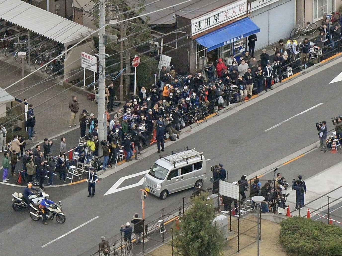 Press gather to witness Ghosn leaving a Tokyo Detention House in March (Reuters)