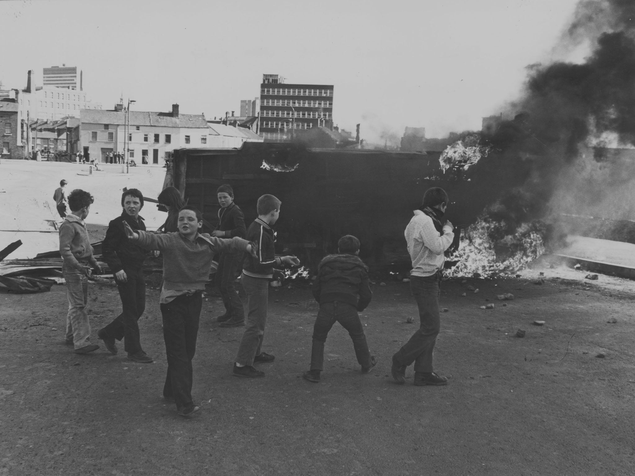 Young boys play around a burning van in Belfast in 1981 (Getty)