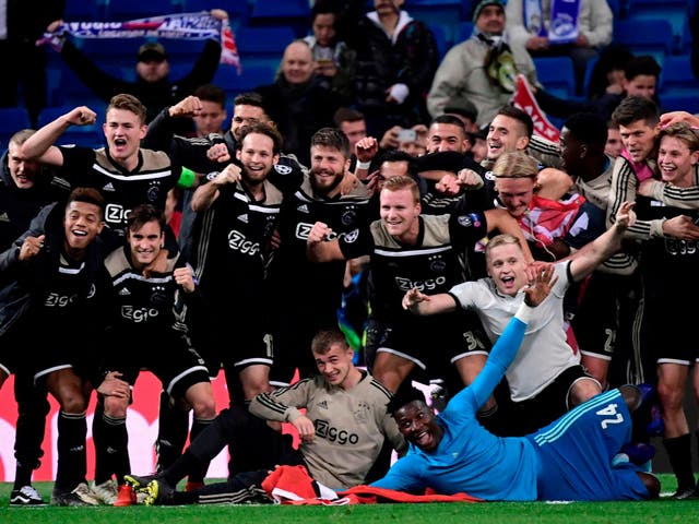 Ajax's players celebrate at the end of the Uefa Champions League match against Real Madrid