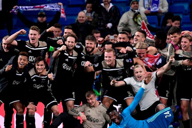 Ajax's players celebrate at the end of the Uefa Champions League match against Real Madrid