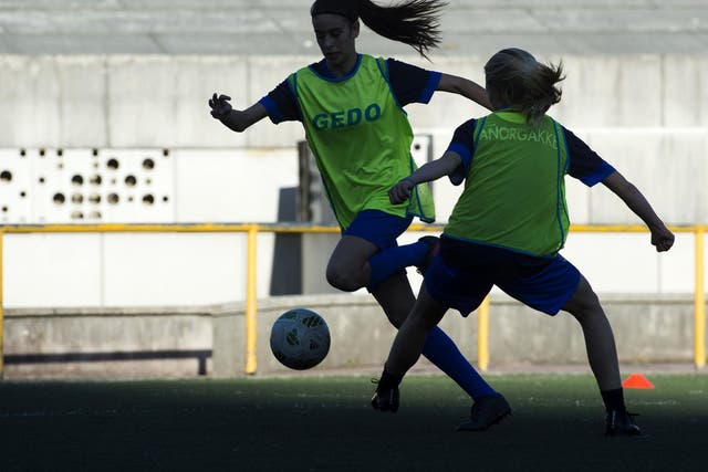 Two girls of Anorga KKE football school attend a training session in the Spanish Basque city of San Sebastian