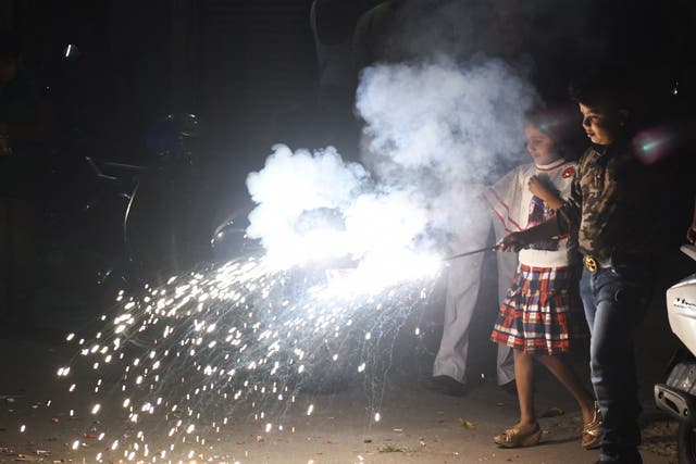 Indian children light firecrackers during Diwali festival