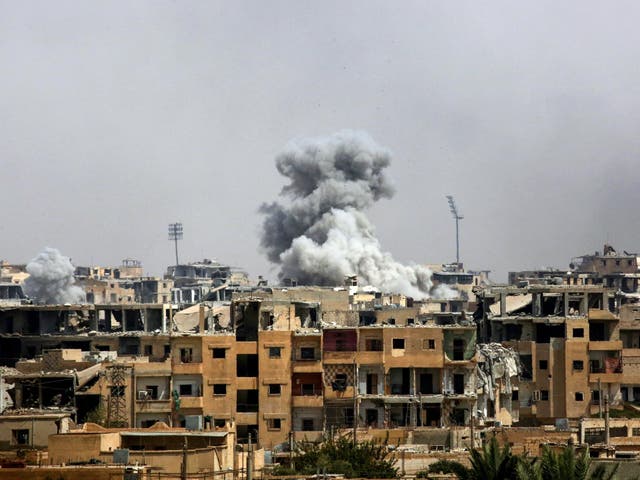 Smoke billows following a coalition airstrike in Raqqa in September 2017