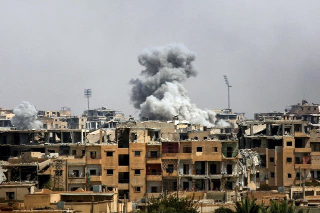 Smoke billows following a coalition airstrike in Raqqa in September 2017
