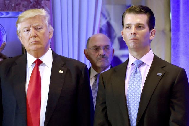 US President-elect Donald Trump along with his son Donald, Jr., arrive for a press conference at Trump Tower in New York, as Allen Weisselberg (C), chief financial officer of The Trump, looks on.
