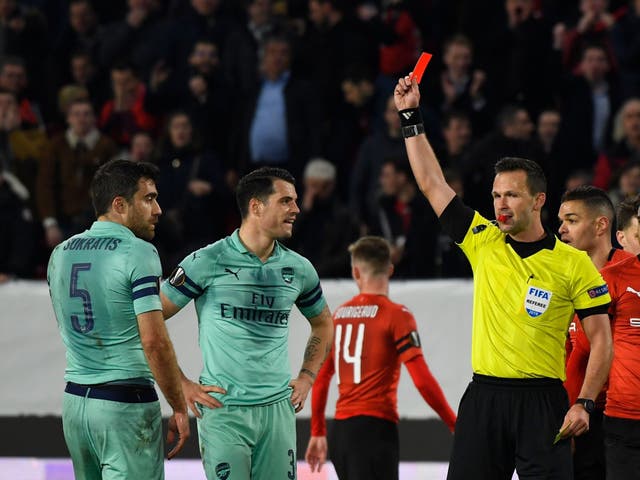 Referee Ivan Kruzliak shows a red card to Arsenal's Sokratis Papastathopoulos
