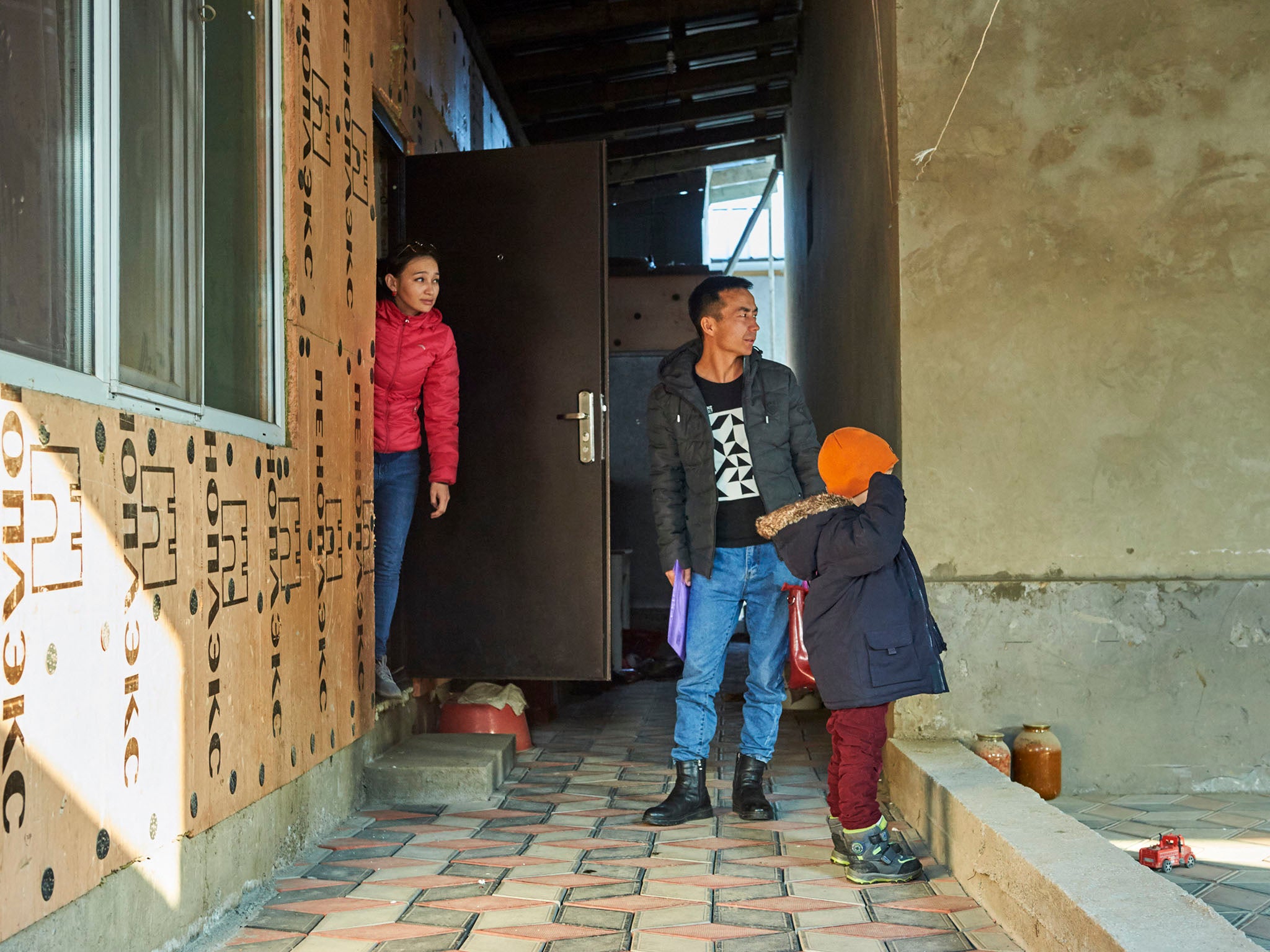 &#13;
&#13;
Otan with his wife Shynar Kylysheva and their six-year-old son outside their home in Almaty (Izturgan Aldauyev for The Washington Post)&#13;