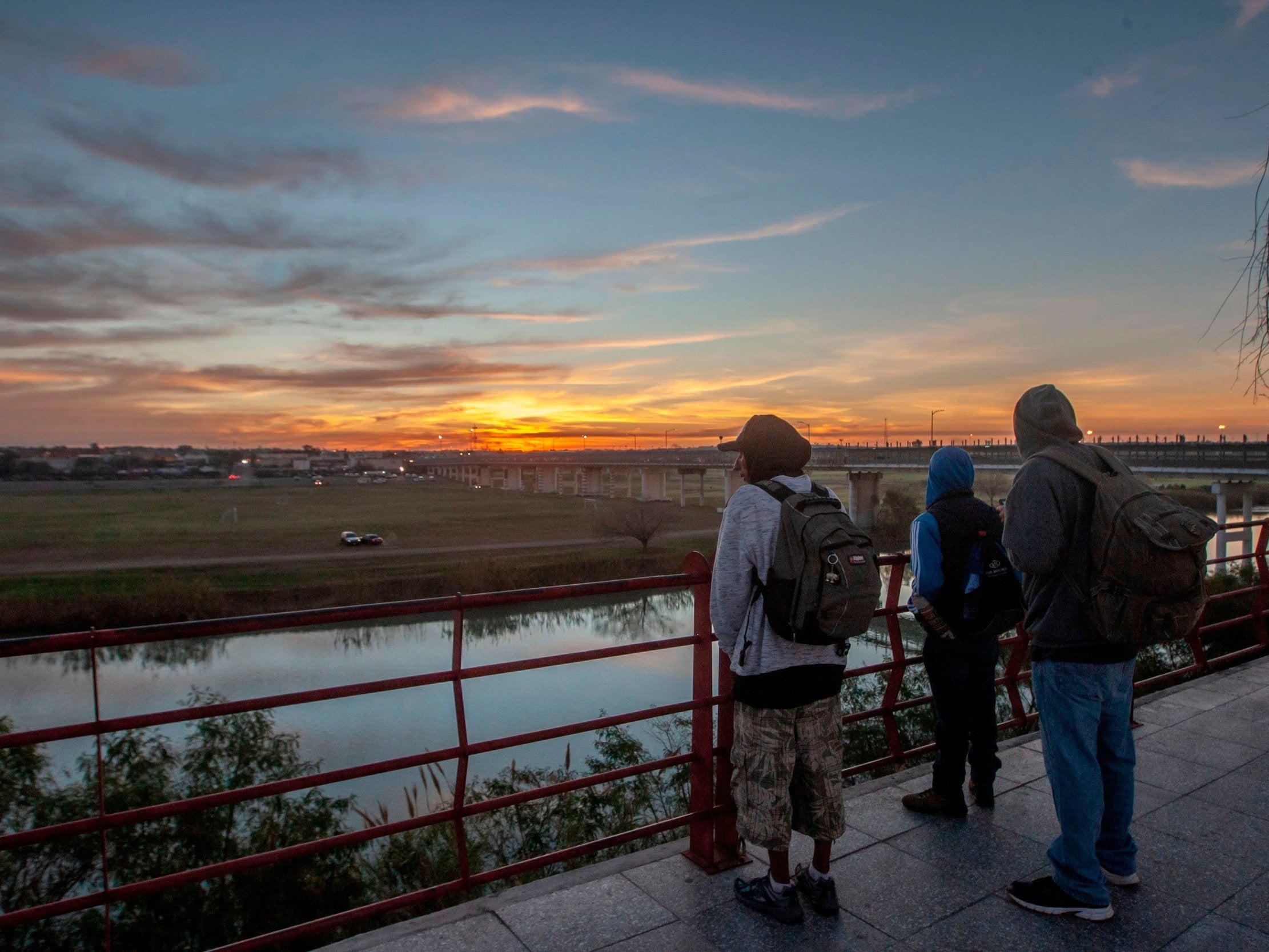 Central American migrants observe the Rio Grande, the river along the US-Mexico border that divides the cities of Piedras Negras in Mexico's Coahuila State and Eagle Pass in Texas.
