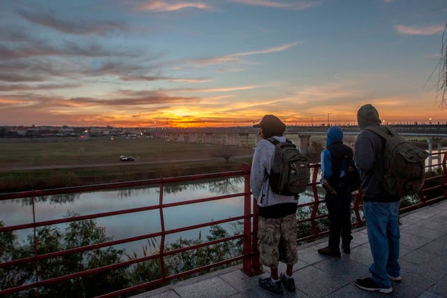 Central American migrants observe the Rio Grande, the river along the US-Mexico border that divides the cities of Piedras Negras in Mexico's Coahuila State and Eagle Pass in Texas.