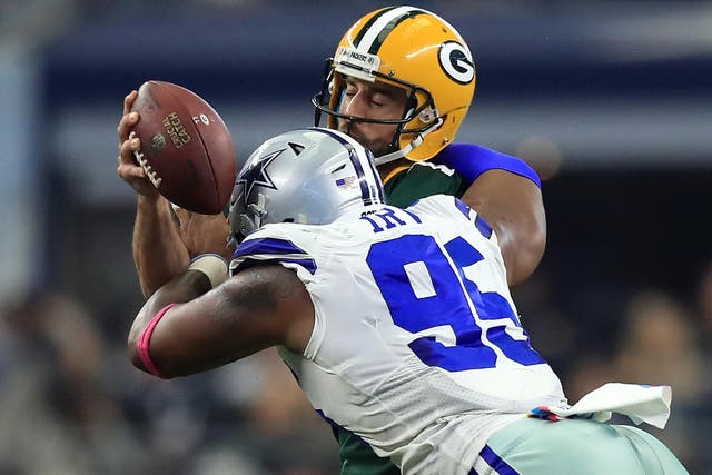 David Irving in action for the Cowboys, sacking quarterback Aaron Rodgers of Green Bay