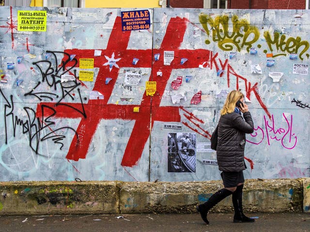 A graffiti-covered wall with a giant hashtag sign near Moscow’s Kursky railway station. Criminal gangs are using tags to advertise channels on popular apps like Telegram where people can buy drugs