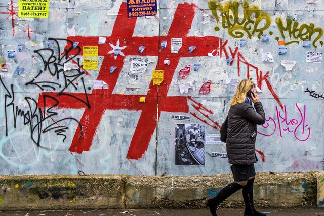 A graffiti-covered wall with a giant hashtag sign near Moscow’s Kursky railway station. Criminal gangs are using tags to advertise channels on popular apps like Telegram where people can buy drugs