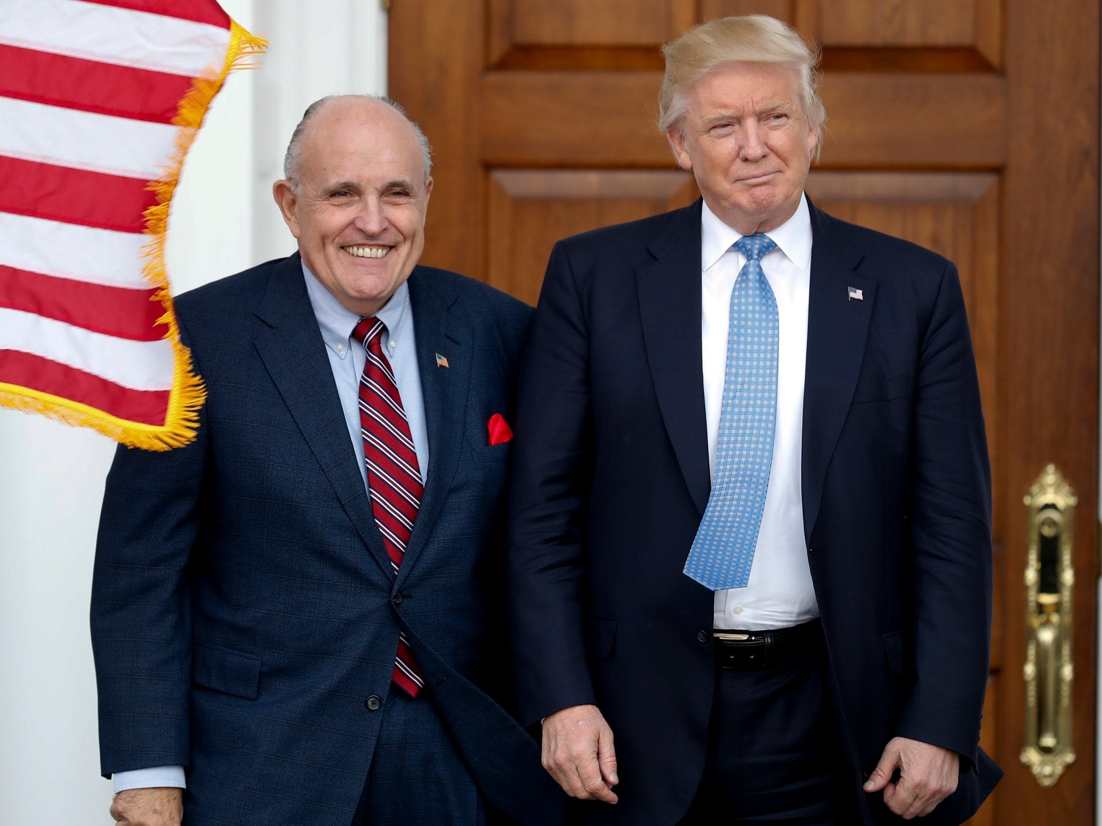 Pictured on 20 November 2016: then-President-elect Donald Trump (right) and former New York Mayor Rudy Giuliani pose for photographs as Giuliani arrives at the Trump National Golf Club Bedminster clubhouse in Bedminster, New Jersey.