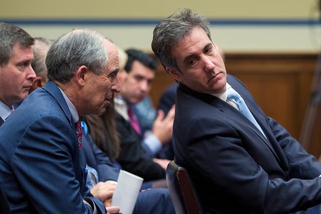 Michael Cohen, right, President Donald Trump's former lawyer, leans back to listen to his lawyer, Lanny Davis of Washington, as he testifies before the House Oversight and Reform Committee, on Capitol Hill, Wednesday in Washington.