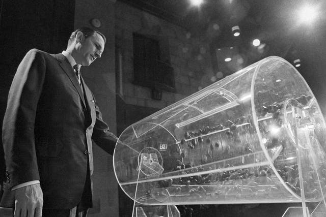 Pictured: Draft Director Curtis W. Tarr spins a Plexiglas drum in Washington as the 4th annual .lottery draw begins on 2 February 1972.