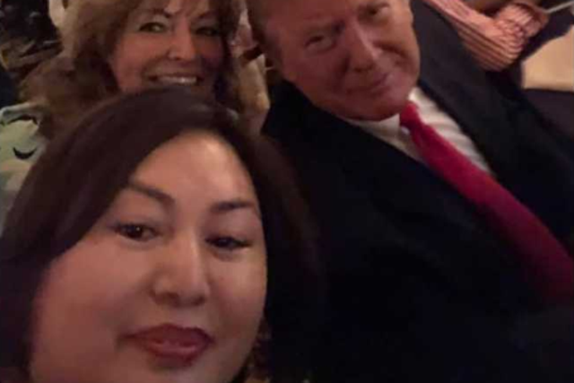 Li Yang takes a selfie with Donald Trump during Super Bowl party
