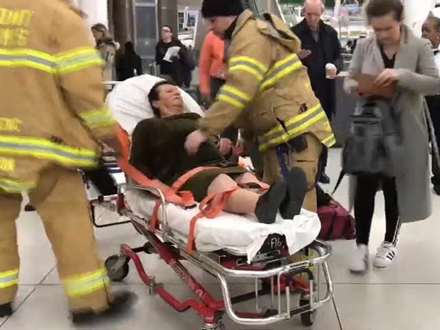 In this still image taken from video provided by WNBC-TV News 4 New York, emergency medical personnel tend to an injured passenger from a Turkish Airlines flight