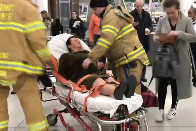 In this still image taken from video provided by WNBC-TV News 4 New York, emergency medical personnel tend to an injured passenger from a Turkish Airlines flight
