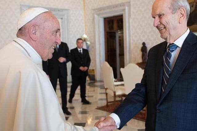 Pope Francis shakes hands with Mormon leaders at the Vatican