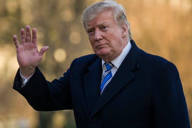 President Donald Trump waves as he walks on the South Lawn after stepping off Marine One at the White House