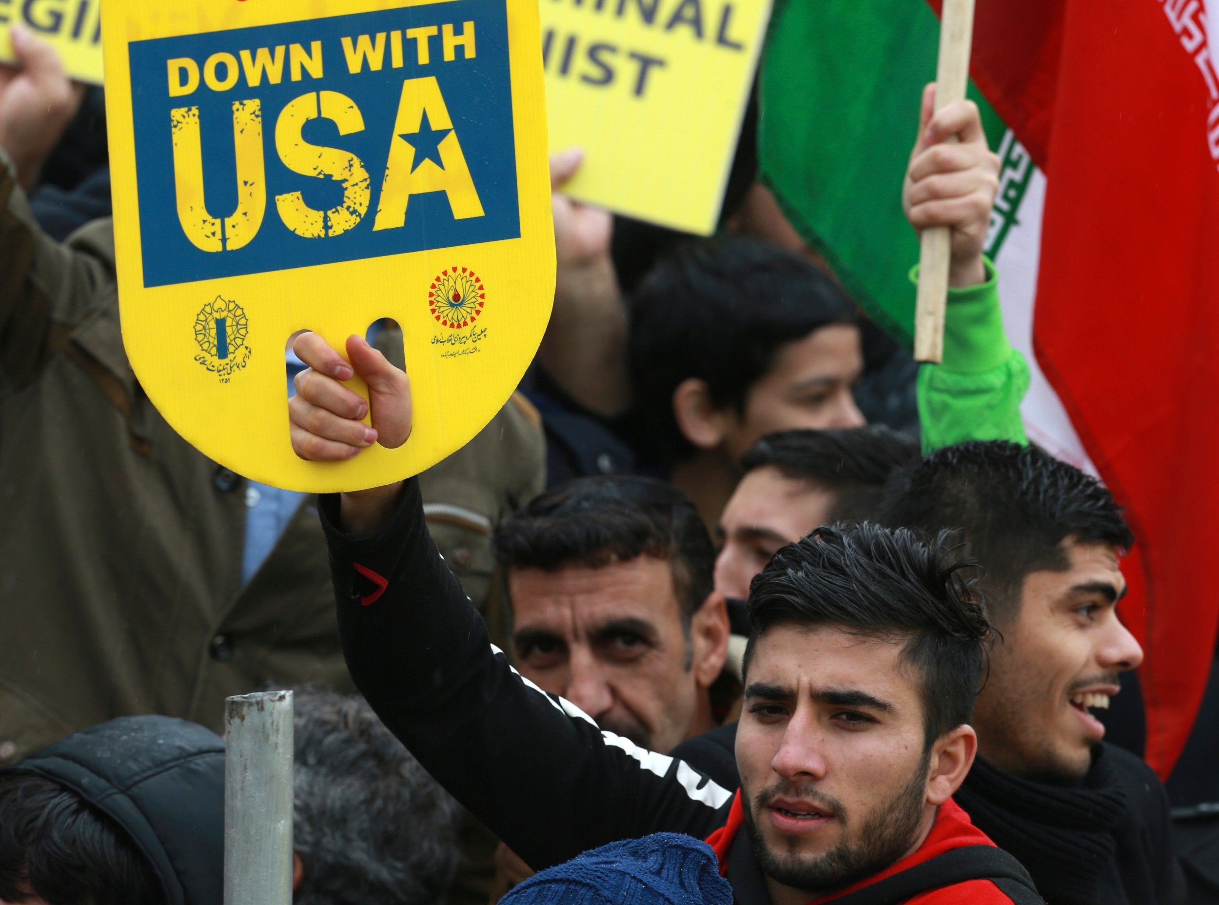 A demonstrator holds an anti-U.S. placard during a ceremony celebrating the 40th anniversary of the Islamic Revolution in Tehran, Iran.