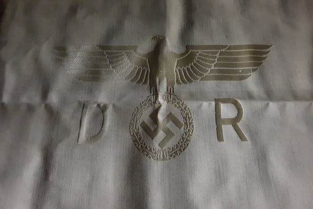 Described as 'historically rare', the tablecloth, napkins and silver cutlery set are emblazoned with swastikas.