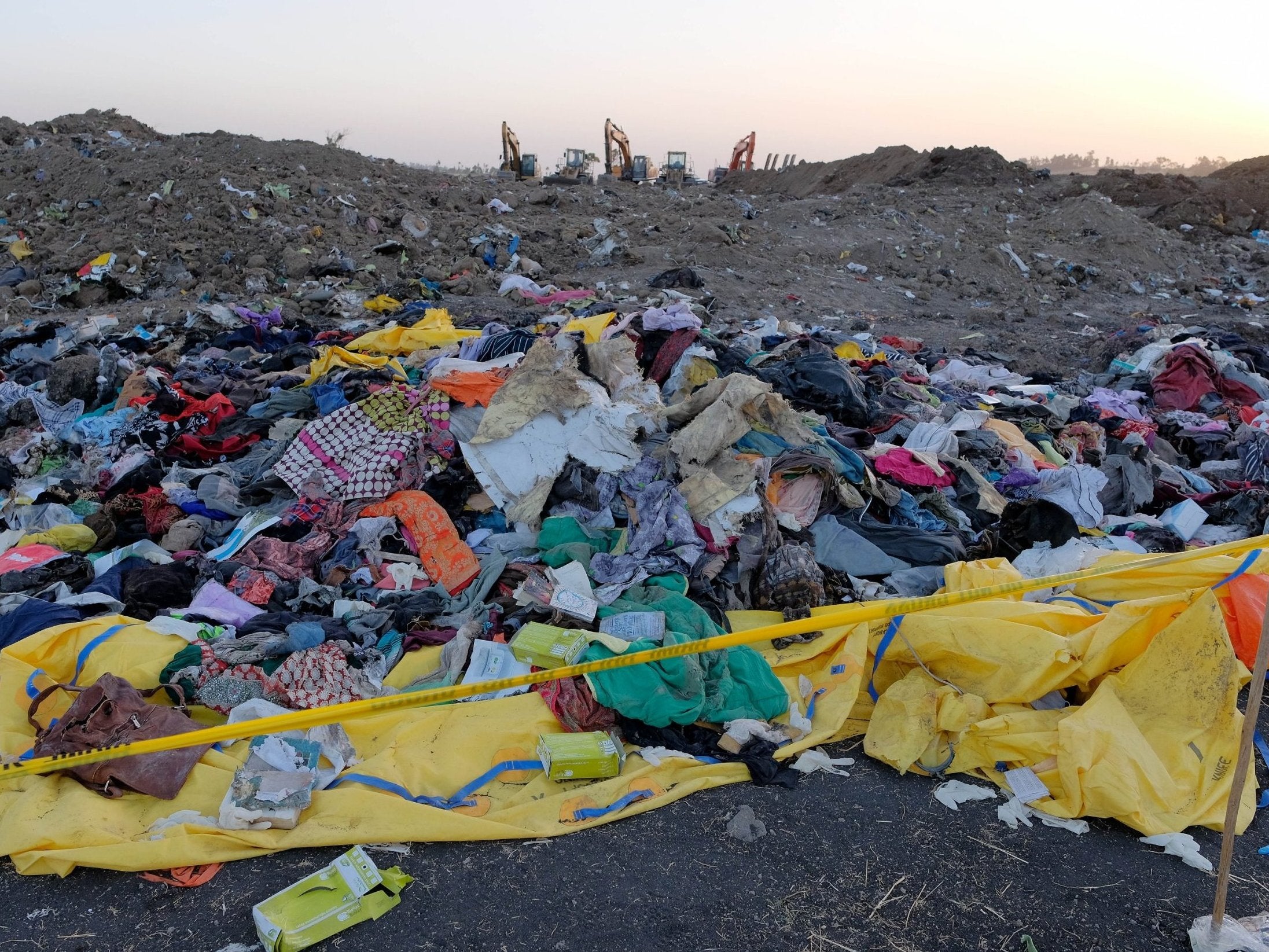 Personal effects lie in a pile after being gathered by workers during the continuing recovery efforts at the crash site of Ethiopian Airlines flight ET302 on 11 March 2019 in Bishoftu, Ethiopia.