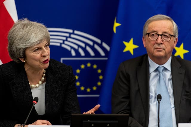 Theresa May and Jean-Claude Juncker speak to journalists during a press conference at the European Parliament in Strasbourg