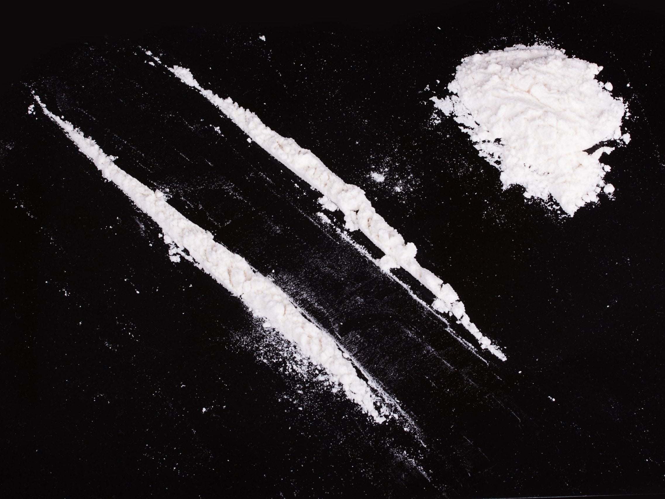 Cocaine powder in lines on a black background