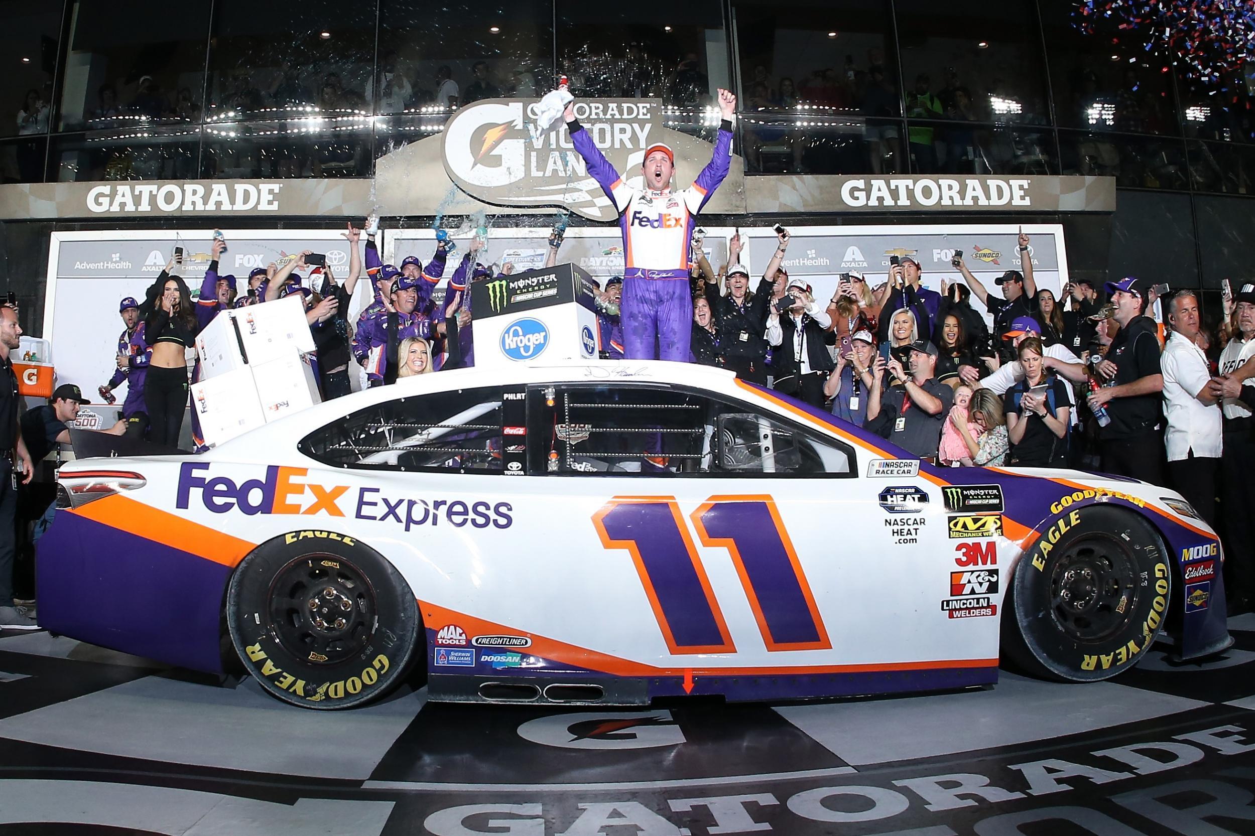 2019 Daytona winner Denny Hamlin emerges from his car after the race