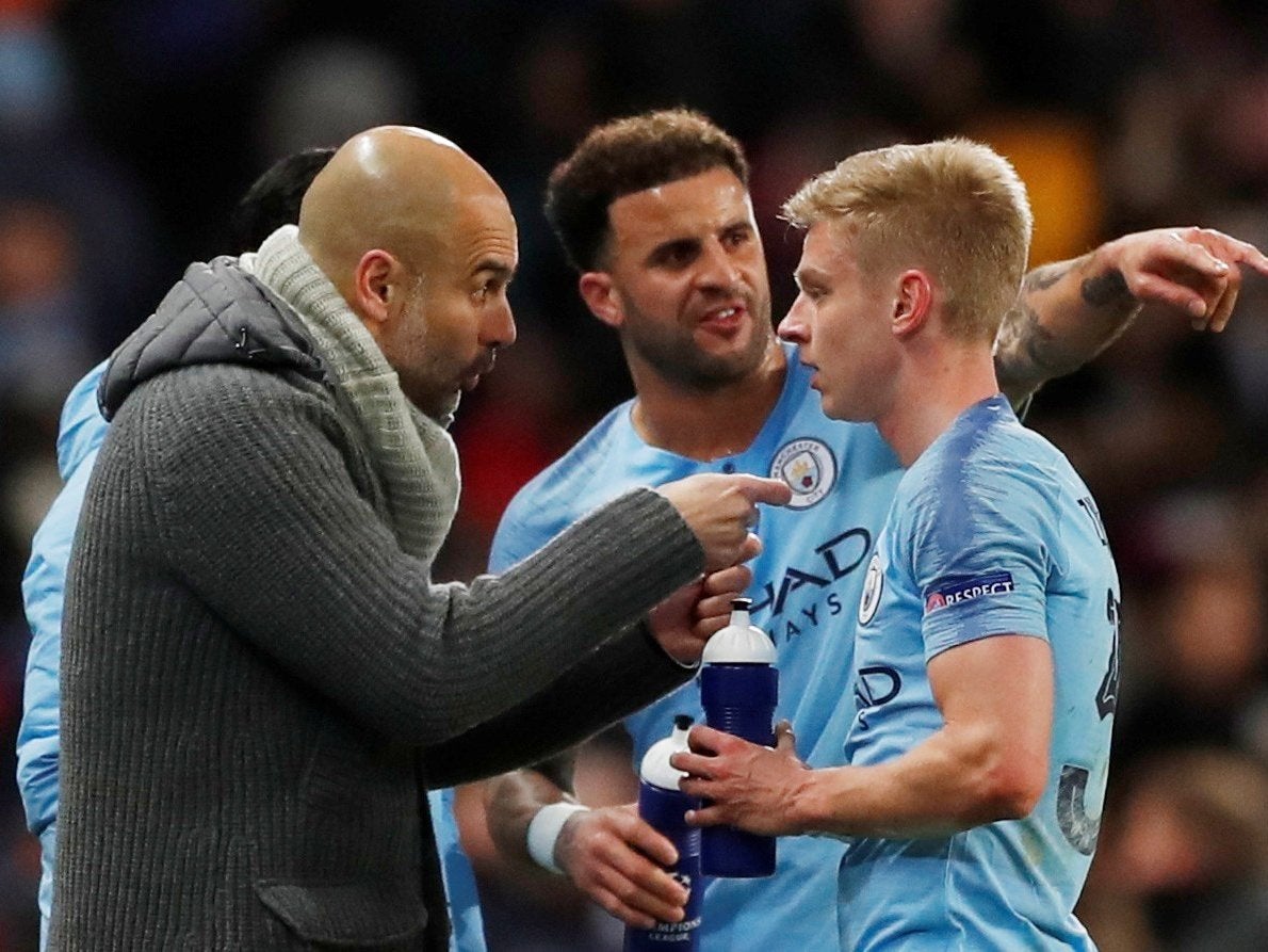 Manchester City manager Pep Guardiola speaks with Oleksandr Zinchenko and Kyle Walker